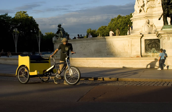 A pedicab in london with the london eye in the background